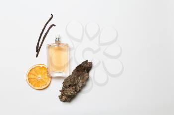 Composition with vanilla perfume on white background�