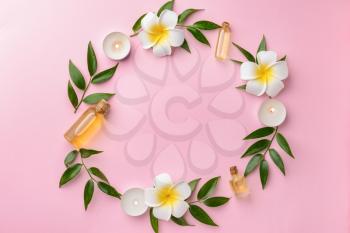 Beautiful spa composition with essential oil on color background�