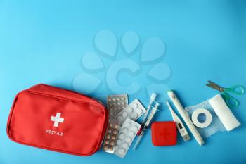 First aid kit on color background�