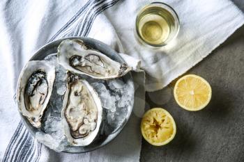 Plate with tasty cold oysters on table�