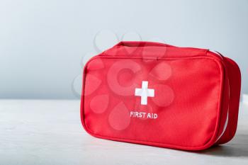 First aid kit on white table�