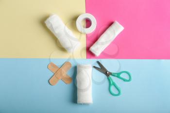 Items from first aid kit on color background�
