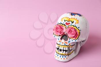 Painted human skull for Mexico's Day of the Dead on color background�