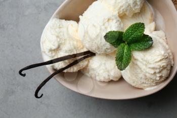 Bowl with tasty vanilla ice-cream on table, closeup�