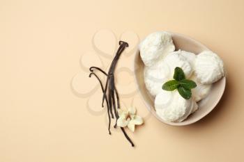 Bowl with tasty vanilla ice-cream on color background�