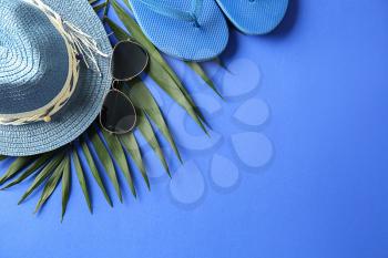 Composition with sunglasses and female accessories on color background�