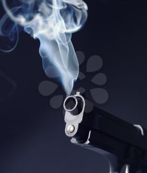 Smoking gun on dark background�