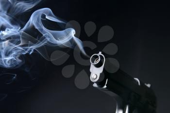 Smoking gun on dark background�