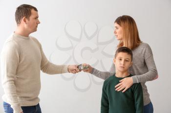 Man giving alimony to his ex-family on light background�
