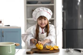 Cute little girl dressed as chef playing at home�