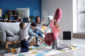 Family fighting pillows at home�