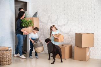 Family with cardboard boxes after moving into new house�