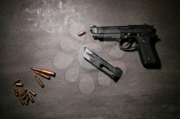 Gun with bullets on grey background�