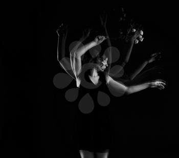 Stroboscopic photo of beautiful moving young woman on dark background�
