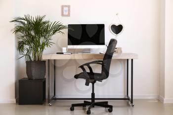 Stylish workplace with modern computer in interior of room�