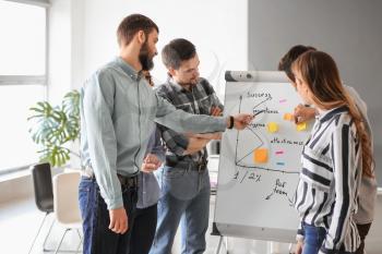 Group of people discussing business plan in office�