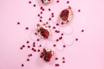 Pieces of ripe pomegranate on color background�