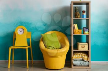 Bright furniture near color wall in kid room�