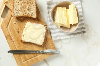 Composition with tasty toasts and butter on table�