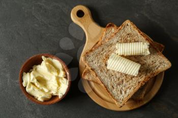 Composition with tasty toasts and butter on table�