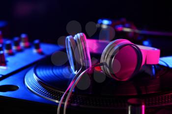 Headphones on modern DJ mixer, closeup�