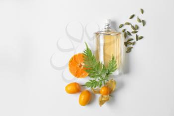 Bottle of citrus perfume on white background�