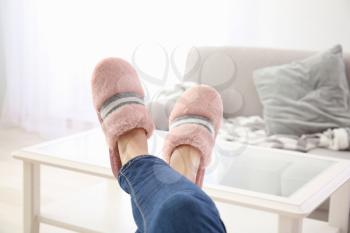 Young woman in slippers resting at home�