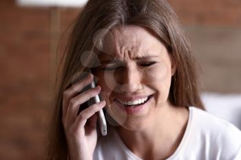Young afraid woman calling for help at home. Suicide concept�