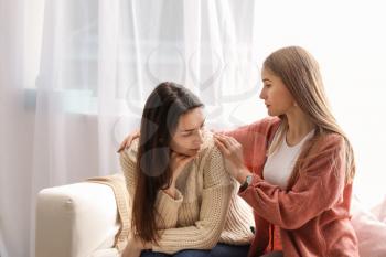 Friend helping young depressed woman at home. Stop a suicide�
