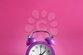 Alarm clock on color background�