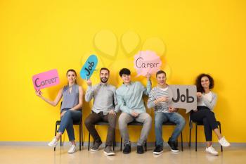 Young people holding speech bubbles with words JOB and CAREER indoors�