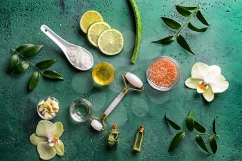 Ingredients for facial mask with massage tool on color background�