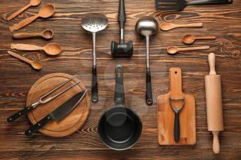 Set of kitchenware on wooden background�
