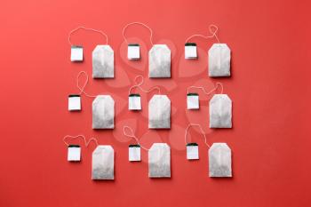 Many tea bags on color background�