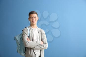 Cute schoolboy on color background�