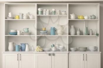 Cupboard with clean dishes in kitchen�