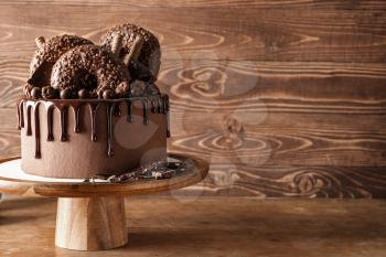 Sweet chocolate cake on wooden table�