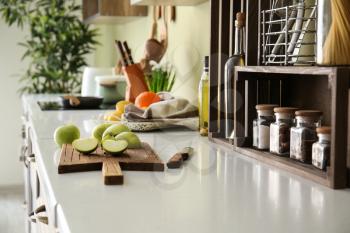 Fresh apple with cutting board on counter in kitchen�