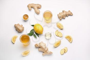 Glasses of healthy drink with ginger and lemon on white background�