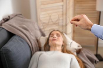 Woman during hypnosis session in psychologist's office�
