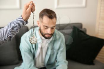 Young man during hypnosis session in psychologist's office�