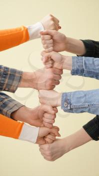 Group of people holding hands together on light background. Concept of unity�