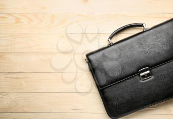 Male briefcase on wooden background�
