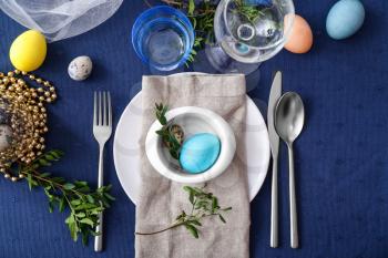 Beautiful Easter table setting on color background�