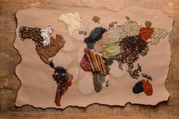 World map made of different spices on wooden background�