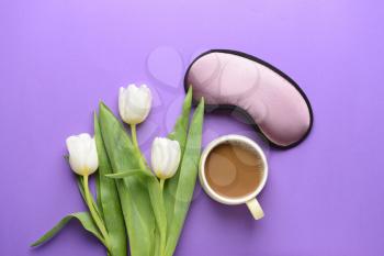 Composition with sleep mask, flowers and coffee on color background 