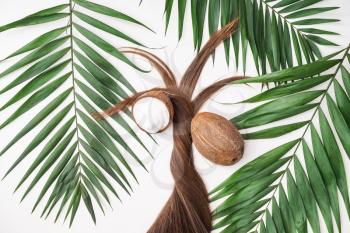 Long hair, coconut and tropical leaves on white background�