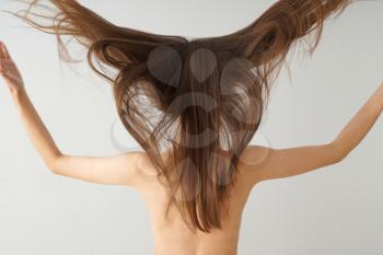 Young woman with beautiful long hair on white background�