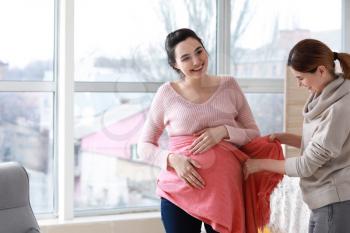 Doula with pregnant woman at home�