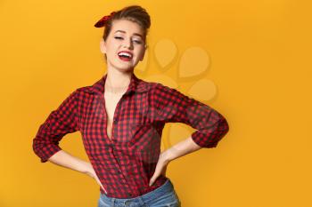 Beautiful pin-up woman on color background�